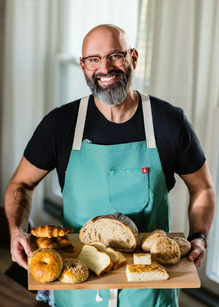 Baker holding his bread