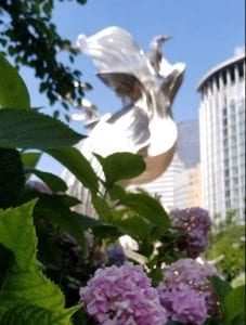 Statue at Charlotte's Romare Bearden Park with Blooming Spring Flowers