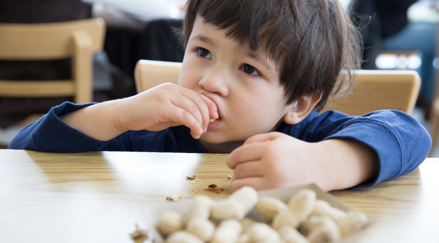 child eating peanuts 