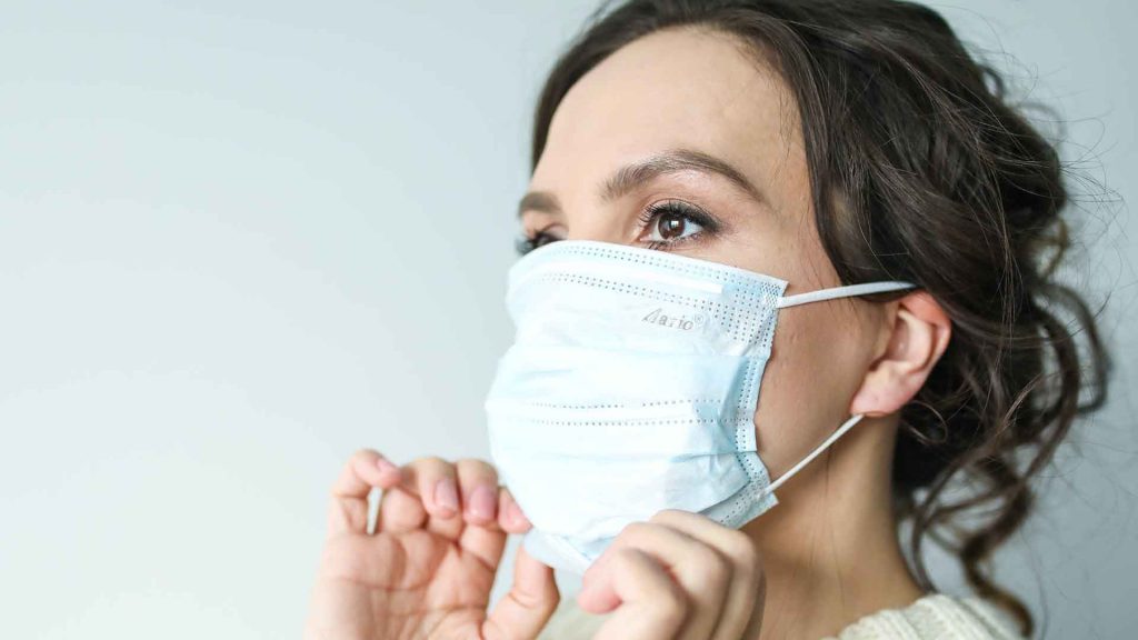 woman with Covid Mask on. Covid vs. Flu vs. cold vs. allergies