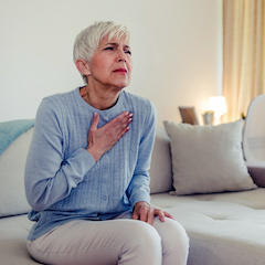 Senior woman suffering from heartburn or chest discomfort symptoms. Acid reflux or Gastroesophageal reflux disease